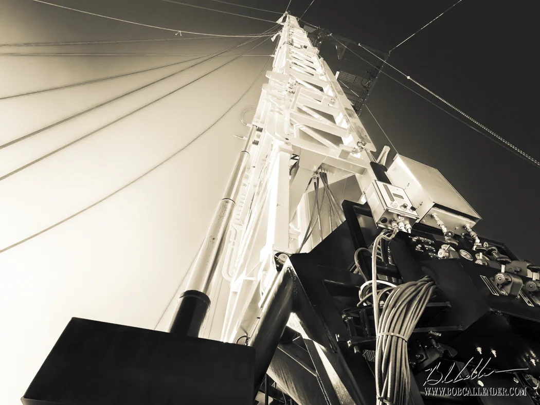 Lucky Services workover rigs operating on a Permian Basin well, low-angle mast view